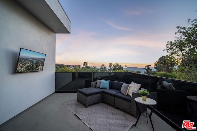 patio terrace at dusk featuring an outdoor hangout area