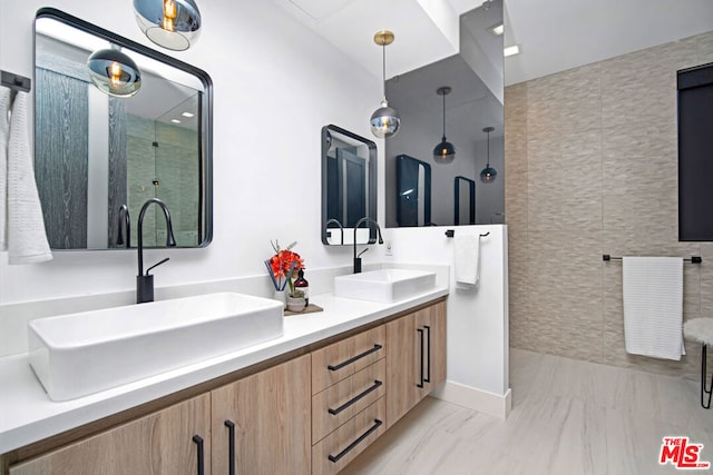 bathroom featuring vanity and tile walls