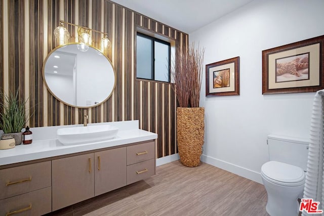 bathroom featuring hardwood / wood-style floors, vanity, and toilet