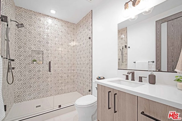 bathroom with vanity, tile patterned floors, toilet, a baseboard radiator, and a tile shower