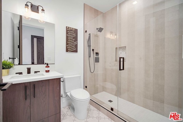 bathroom with vanity, toilet, and a shower with door