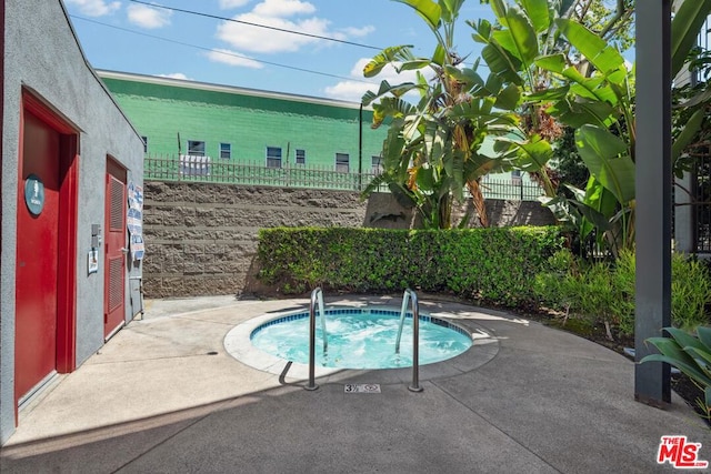 view of pool featuring a hot tub