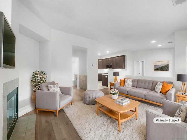 living room featuring a fireplace and hardwood / wood-style floors