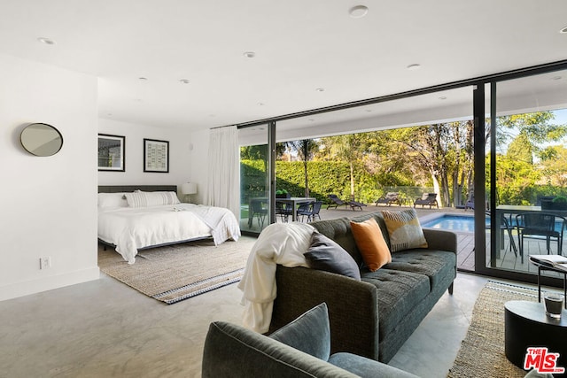 bedroom featuring access to outside and floor to ceiling windows