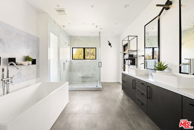 bathroom featuring vanity, plus walk in shower, and tile walls