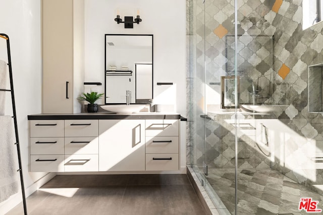 bathroom with vanity and a shower with shower door