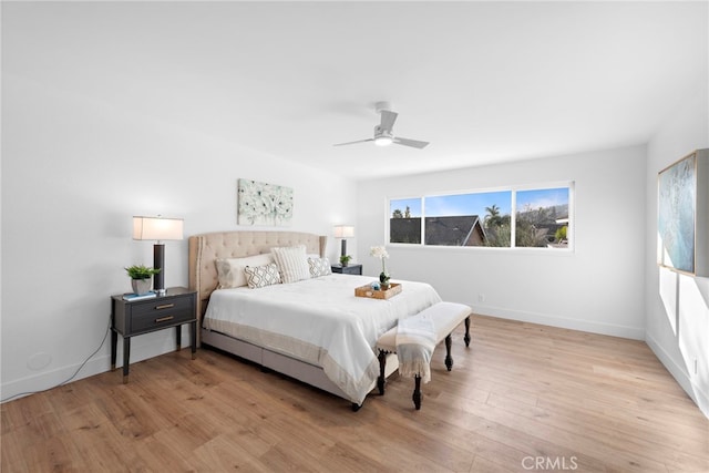 bedroom with ceiling fan and light hardwood / wood-style floors