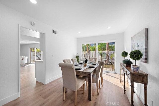 dining room featuring light hardwood / wood-style flooring and a healthy amount of sunlight