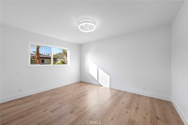 spare room with light hardwood / wood-style floors