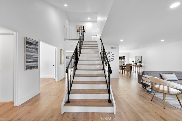 stairs featuring wood-type flooring