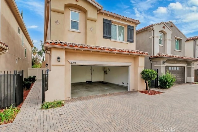 mediterranean / spanish-style house with a garage