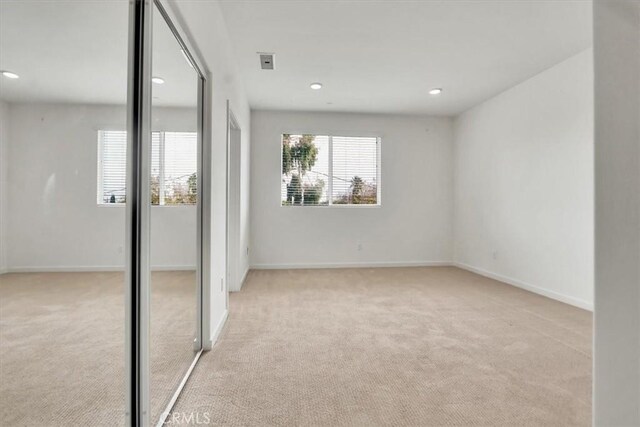 unfurnished bedroom with light colored carpet