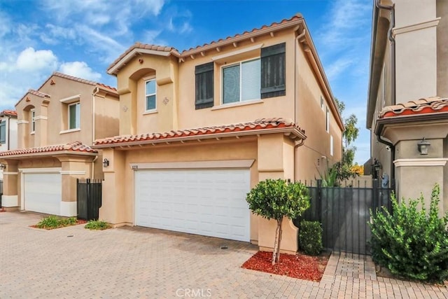 mediterranean / spanish house with a garage