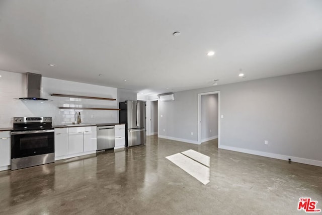 kitchen with wall chimney exhaust hood, appliances with stainless steel finishes, tasteful backsplash, concrete floors, and white cabinetry