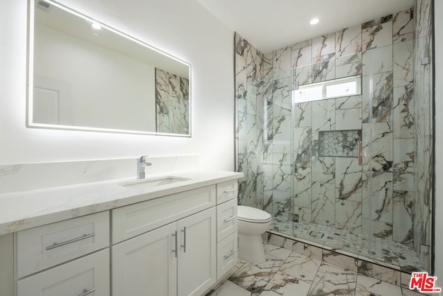 bathroom featuring a shower with door, vanity, and toilet