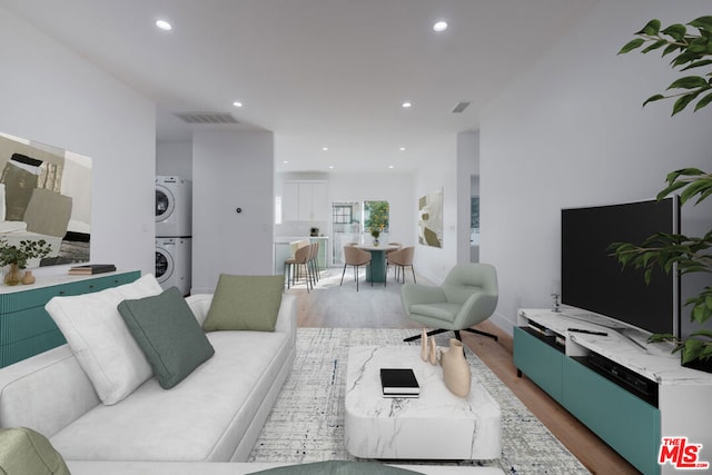 living room featuring hardwood / wood-style floors and stacked washing maching and dryer