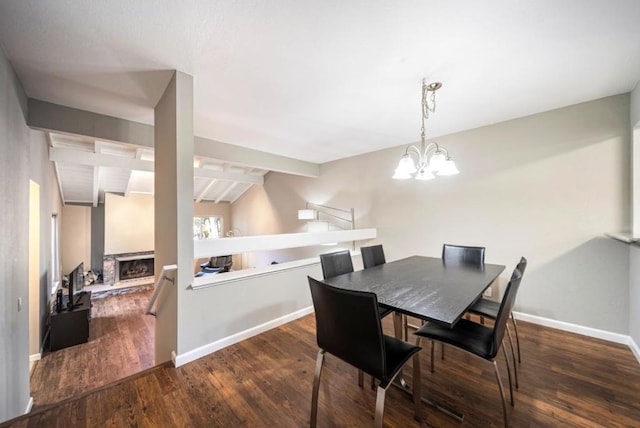 dining room featuring a notable chandelier, dark hardwood / wood-style flooring, and vaulted ceiling with beams