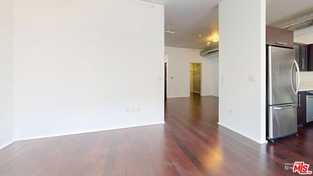 empty room featuring dark wood-type flooring