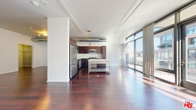 unfurnished living room featuring dark hardwood / wood-style flooring and a wall of windows