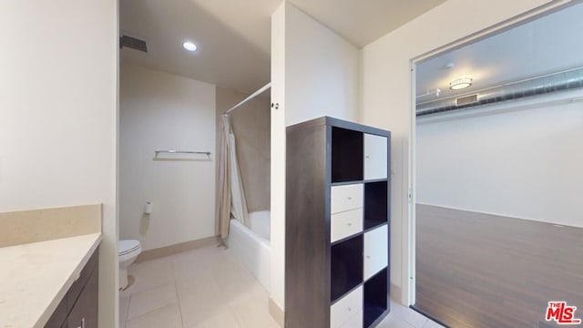 full bathroom with vanity, wood-type flooring, shower / bath combo, and toilet