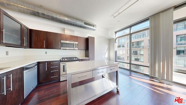 kitchen with dark hardwood / wood-style flooring, plenty of natural light, and appliances with stainless steel finishes