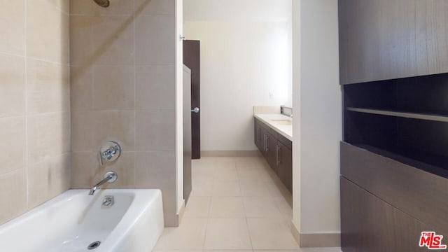 bathroom featuring tile patterned flooring, vanity, and tiled shower / bath combo