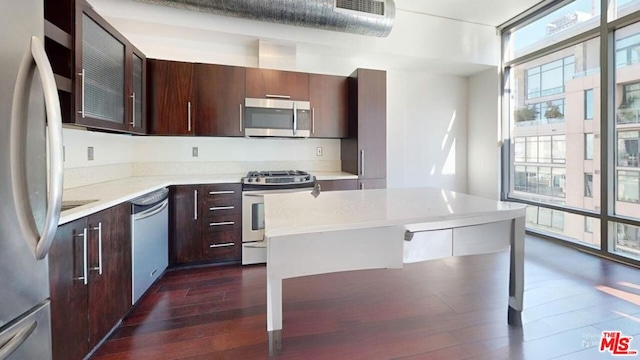 kitchen with dark wood-type flooring, stainless steel appliances, and dark brown cabinets