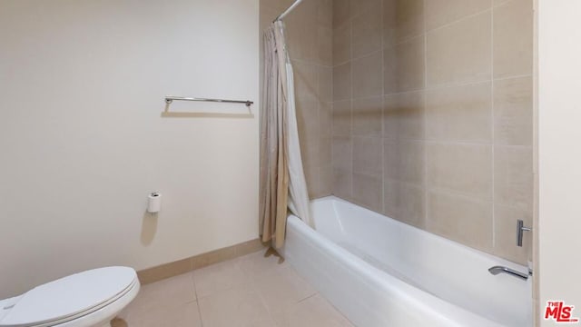 bathroom featuring tile patterned floors, shower / tub combo, and toilet