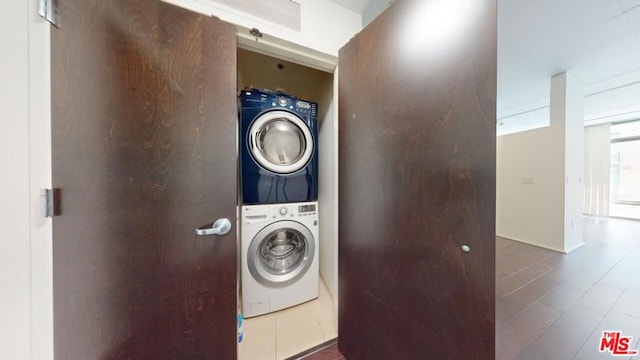 laundry area featuring stacked washer / drying machine