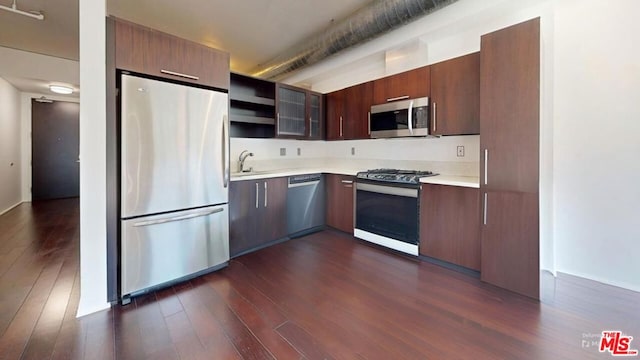 kitchen featuring stainless steel appliances and dark wood-type flooring