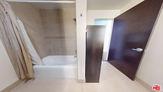 bathroom with shower / bath combination with curtain and tile patterned floors