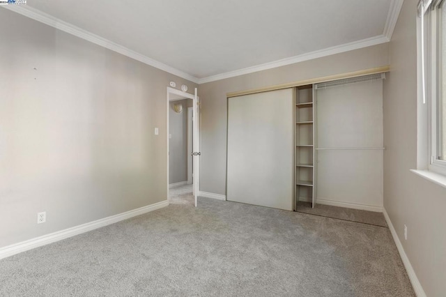 unfurnished bedroom featuring carpet, a closet, and ornamental molding