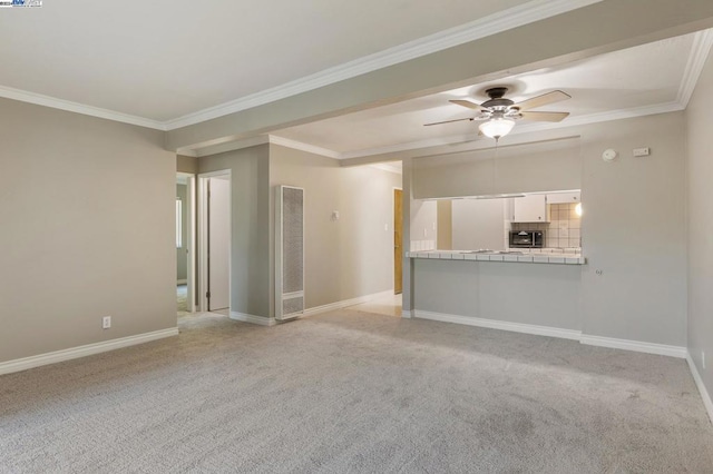 unfurnished living room with crown molding, ceiling fan, and light carpet