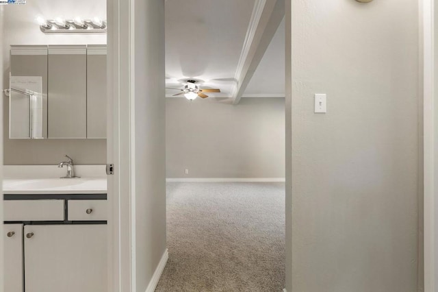 bathroom featuring vanity, beam ceiling, crown molding, and ceiling fan