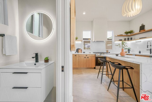 bathroom with decorative backsplash and vanity