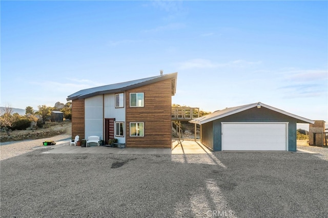 modern home with a garage and an outbuilding