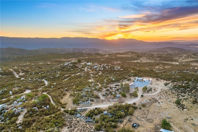 aerial view at dusk featuring a mountain view