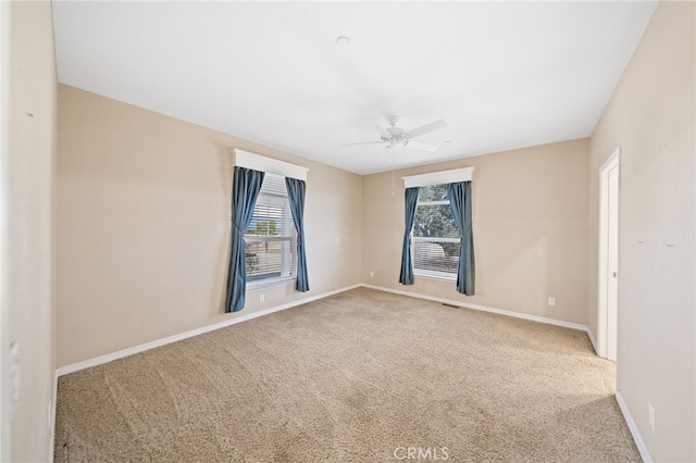 spare room with carpet and ceiling fan