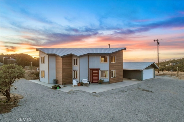 modern home with a garage and an outbuilding