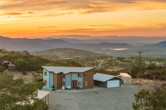 exterior space featuring a mountain view, a storage shed, and a garage