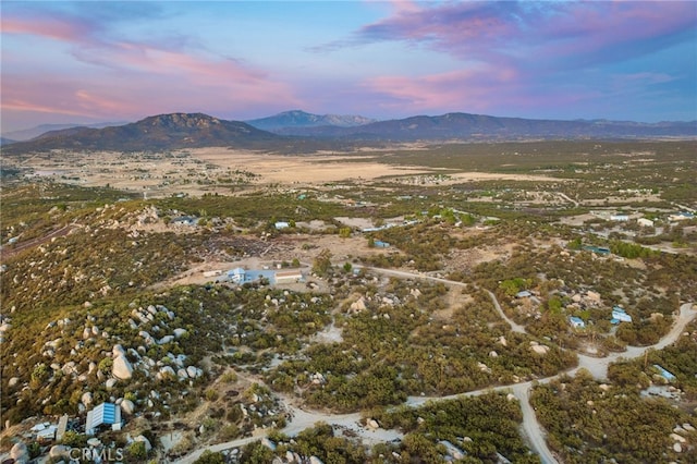 aerial view at dusk featuring a mountain view