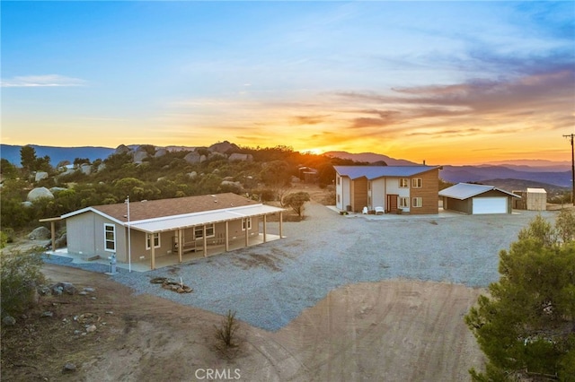 view of front of house featuring a garage, a mountain view, and an outdoor structure