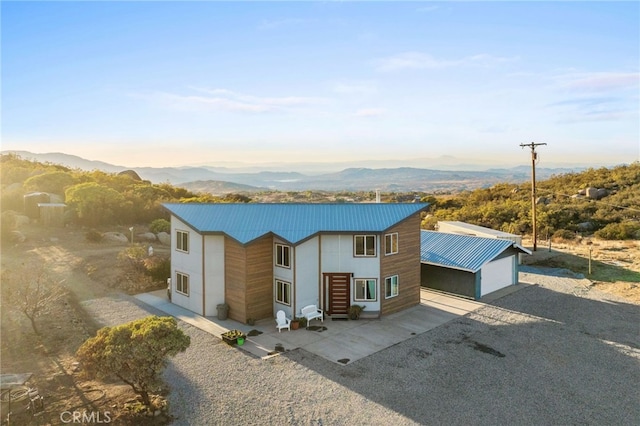 view of front of home with a garage and a mountain view