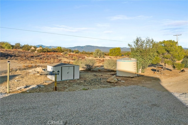 view of yard featuring a shed and a mountain view