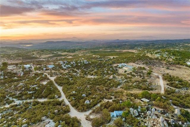 aerial view at dusk featuring a mountain view