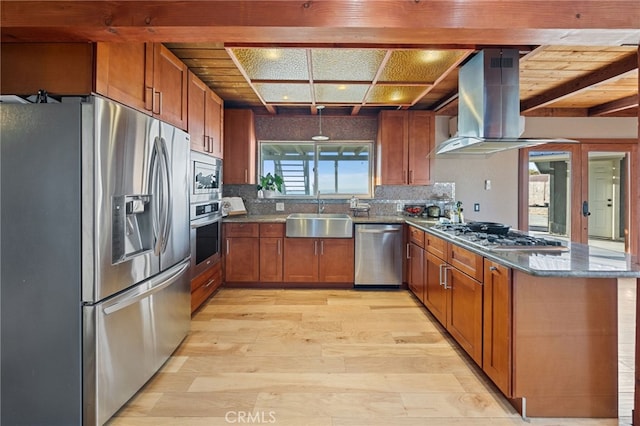 kitchen featuring sink, light wood-type flooring, island range hood, beamed ceiling, and stainless steel appliances