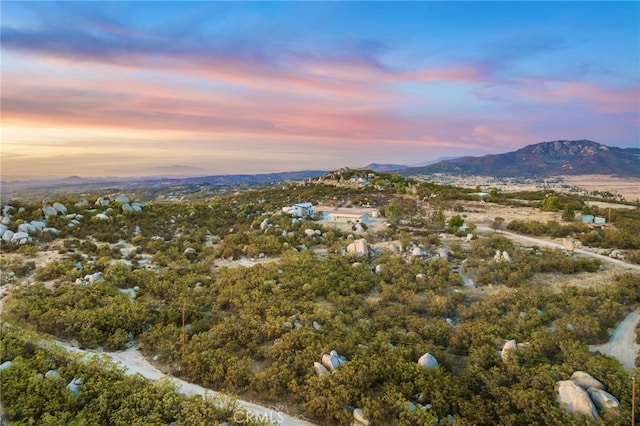 aerial view at dusk featuring a mountain view