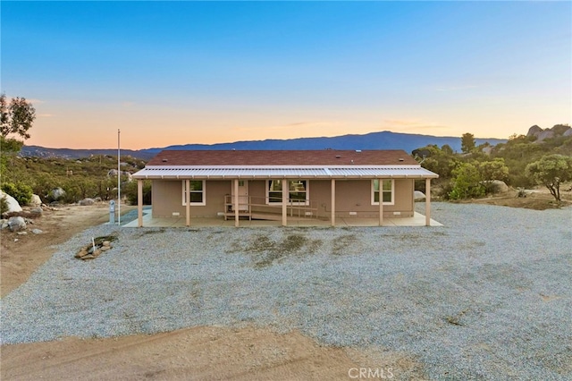 view of front facade with a patio area and a mountain view