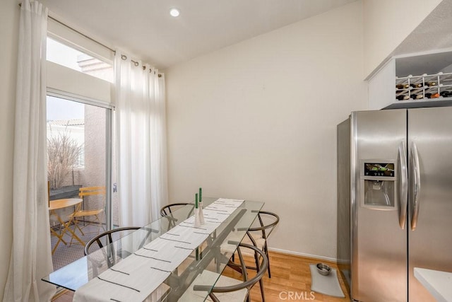 dining room with light wood-type flooring, baseboards, and recessed lighting