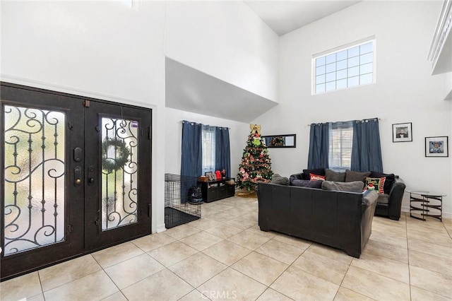 tiled foyer entrance with a high ceiling and french doors